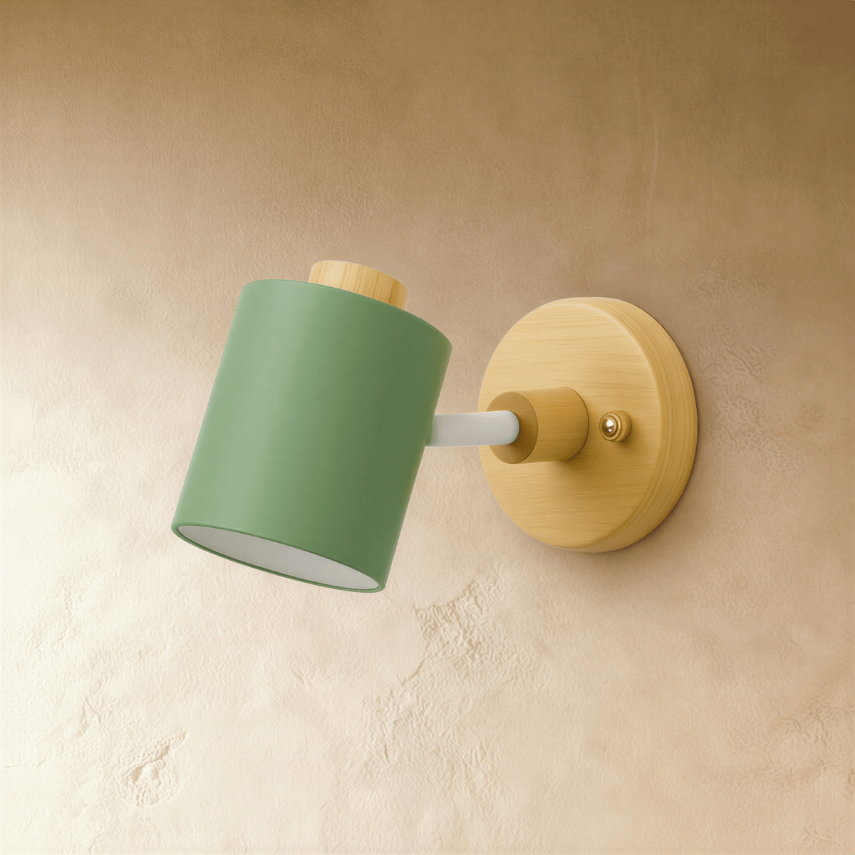 Clérachic wall lamp with a muted green cylindrical metal shade on a pale wooden backplate, shown unlit against a limewash wall.