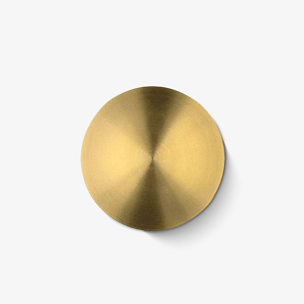 Round brushed brass wall light from Clérachic, with a fine circular grain radiating from the centre, on a plain white backdrop.