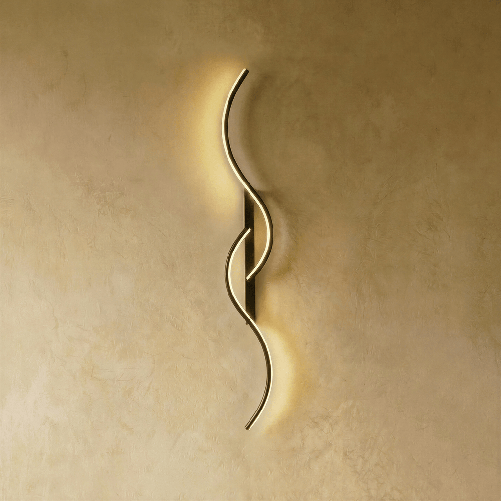 Clérachic black S-shaped wall light with slim interlocking LED curves and a narrow backplate, lit softly on warm plaster.