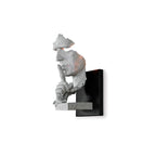 White Clérachic wall light, unlit, with the sculpted face and hand shown against a plain white background.
