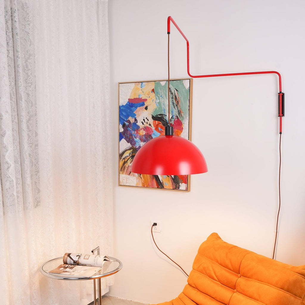 Red shade of this Clérachic wall light swung in front of an abstract painting, with sheer curtains and an orange sofa nearby.