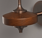 Close view of the grained walnut wood disc, bronze collar and tapering finial on this Clérachic wall sconce.
