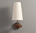 One white fabric shade on a Clérachic single wall sconce, with a walnut disc and bronze arm against a mid-grey wall.