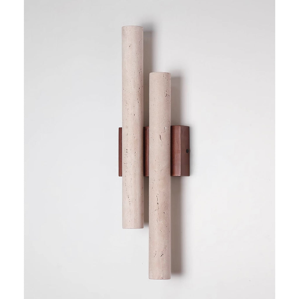 Unlit Clérachic wall light on a pale wall, its two long travertine tubes mounted on a dark walnut-wood plate.