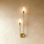 Clérachic brass wall light, mirror-image version, with two frosted glass cylinders on a tall U-shaped arm and a round backplate.