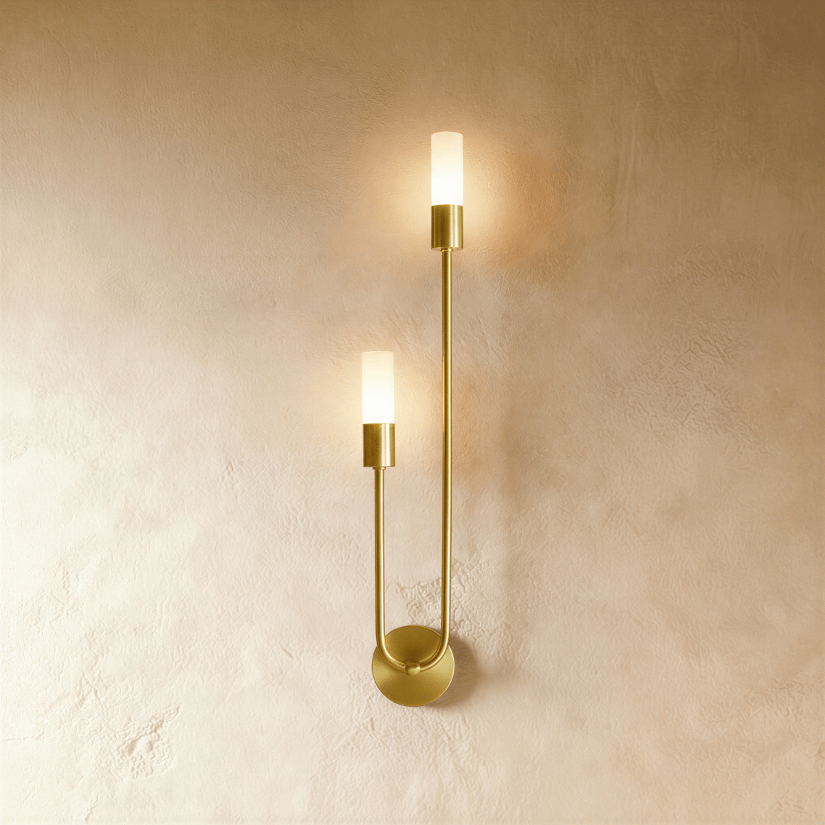 Clérachic brass wall light, mirror-image version, with two frosted glass cylinders on a tall U-shaped arm and a round backplate.