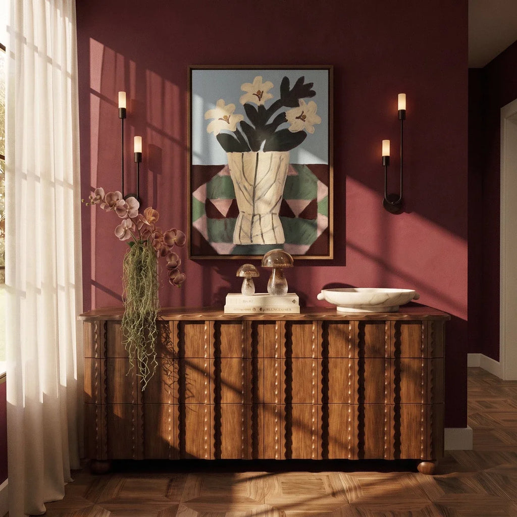 Clérachic pair of black wall lights, one of each hand, flanking a framed print above a carved wooden dresser on a burgundy wall.