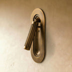 Clérachic embedded wall light in aged brass, unlit, the fluted cylinder tilted out of a stepped oval recess