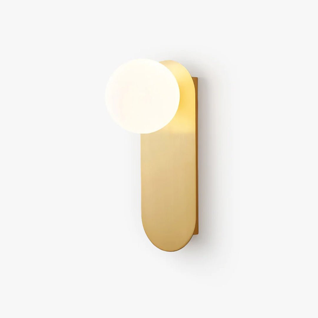 Brass wall light with a white glass globe on a tall rounded-end flat plate, from Clérachic, on a plain white backdrop.