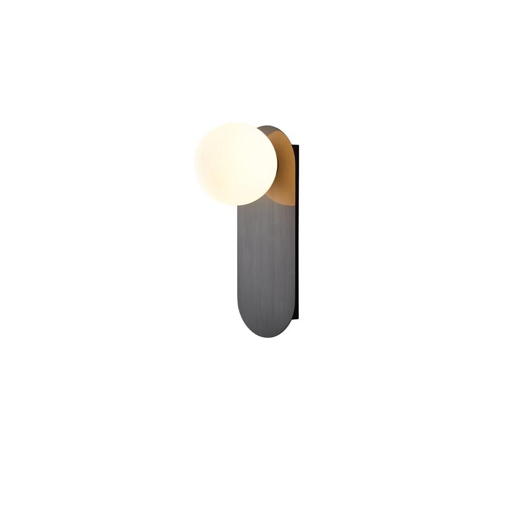 Black plate with a lit white globe and a brass glint behind it, this Clérachic wall light on a white background.