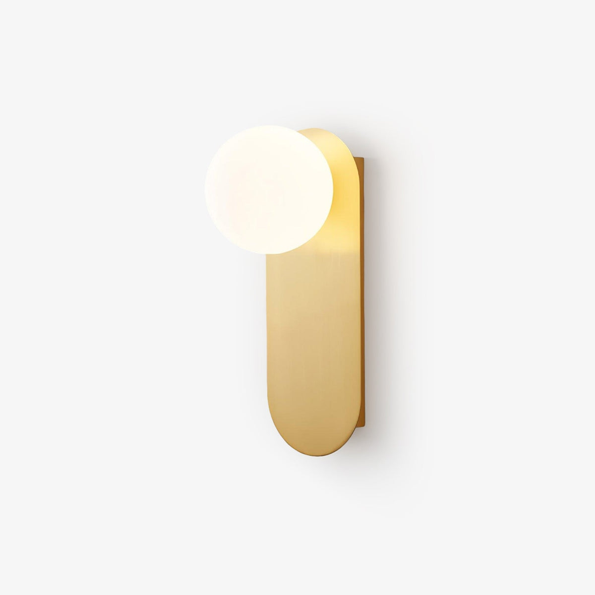Brass wall light with a white globe and a tall rounded plate, a Clérachic design shown on a pale backdrop at an angle.
