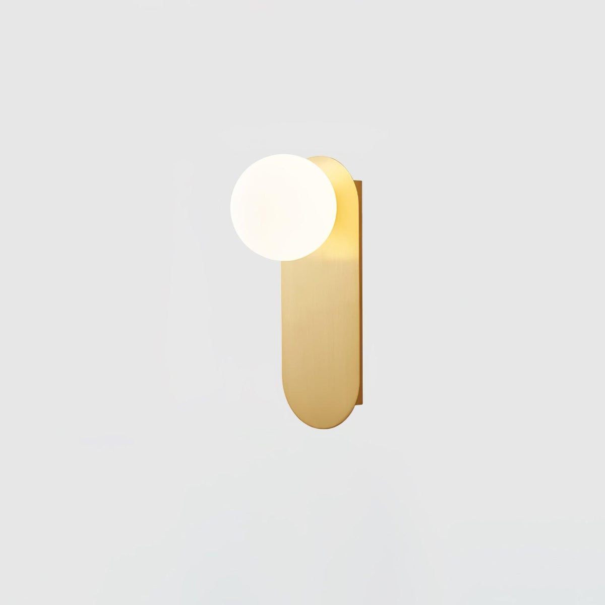 Smaller view of the brass globe wall light from Clérachic, its white globe and rounded plate on a pale grey background.