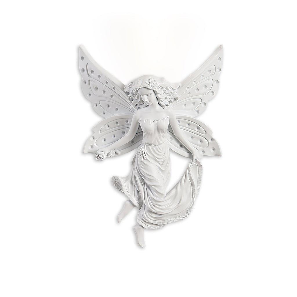 Fairy-shaped Clérachic wall light on white, its perforated butterfly wings and draped skirt in cast white resin.