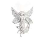 Fairy-shaped Clérachic wall light on white, its perforated butterfly wings and draped skirt in cast white resin.