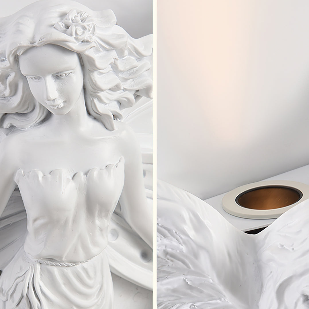 Two close views of this Clérachic wall light: the sculpted face and bodice of the figure, and the uplight opening above the wings.