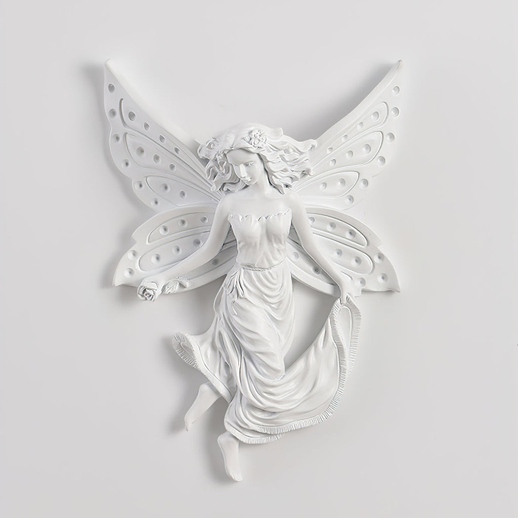 Unlit fairy-shaped Clérachic wall light on a pale wall, its perforated butterfly wings and flowing skirt in white resin.
