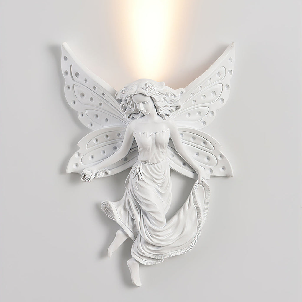 Lit fairy-shaped Clérachic wall light on a pale wall, the warm uplight spreading above its perforated wings.