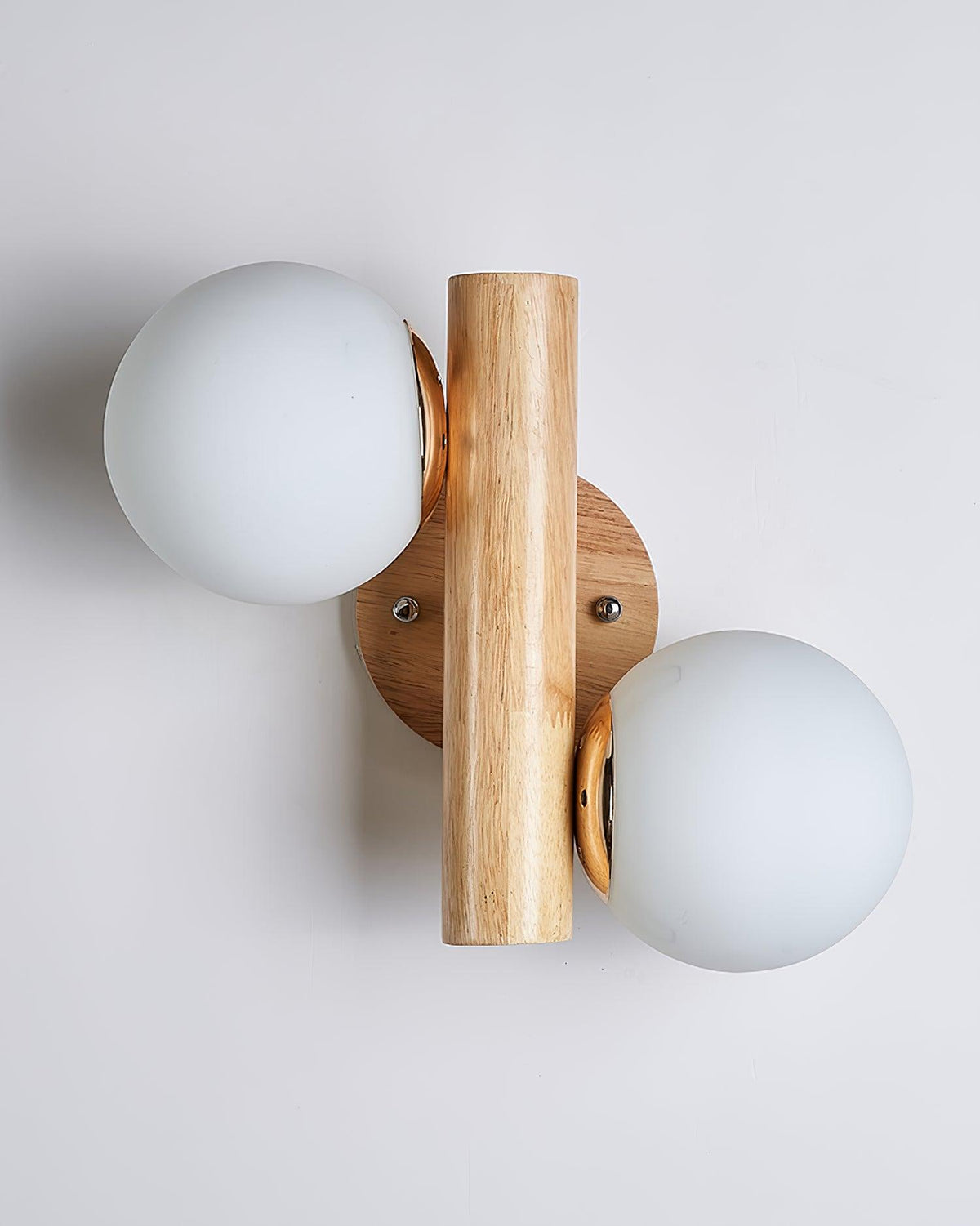 Straight-on view of this Clérachic sconce unlit, with a white globe on each side of the upright wooden rod and a round backplate.