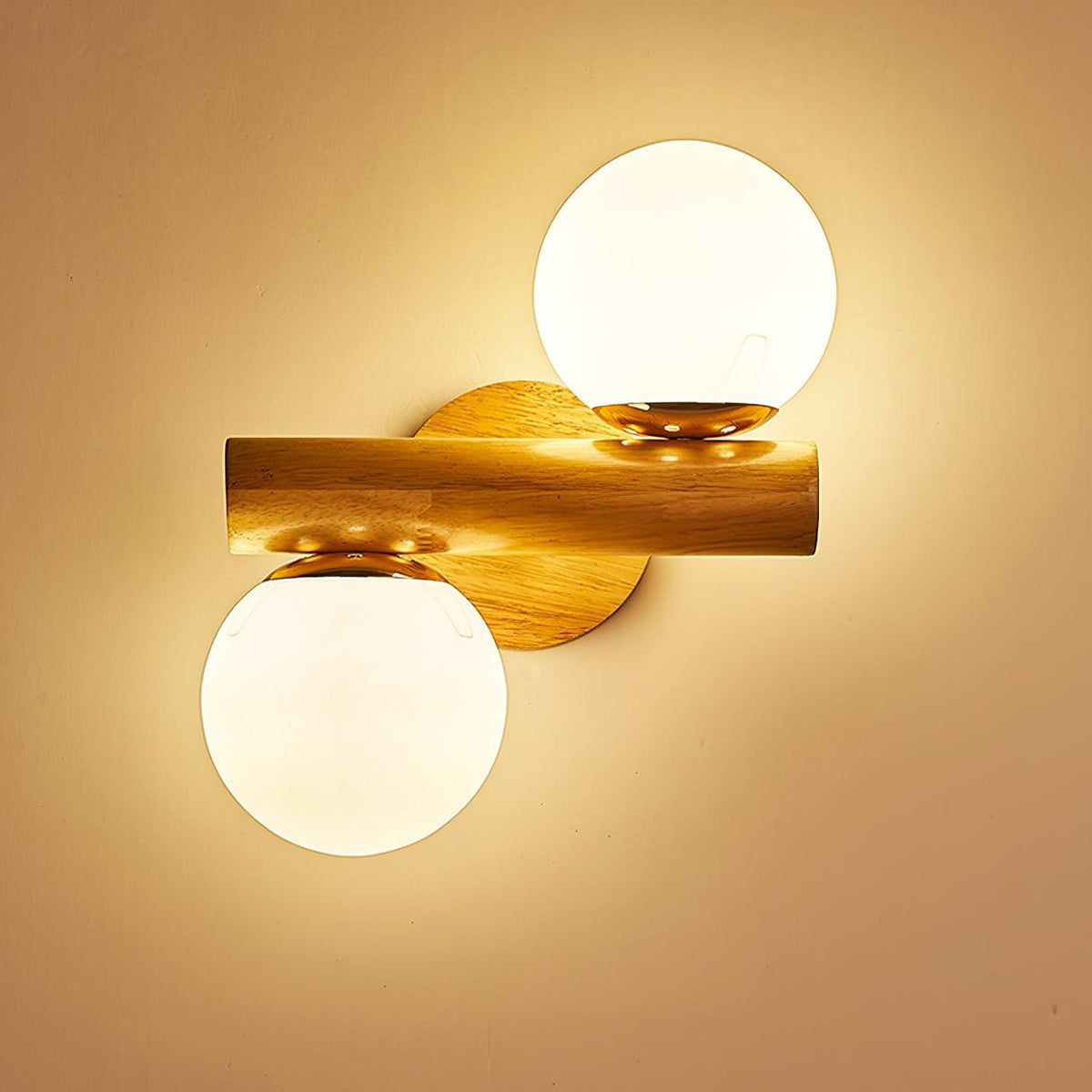 Two glowing globes on this Clérachic wood sconce, its rod set horizontally and a honey-coloured light washing the wall.