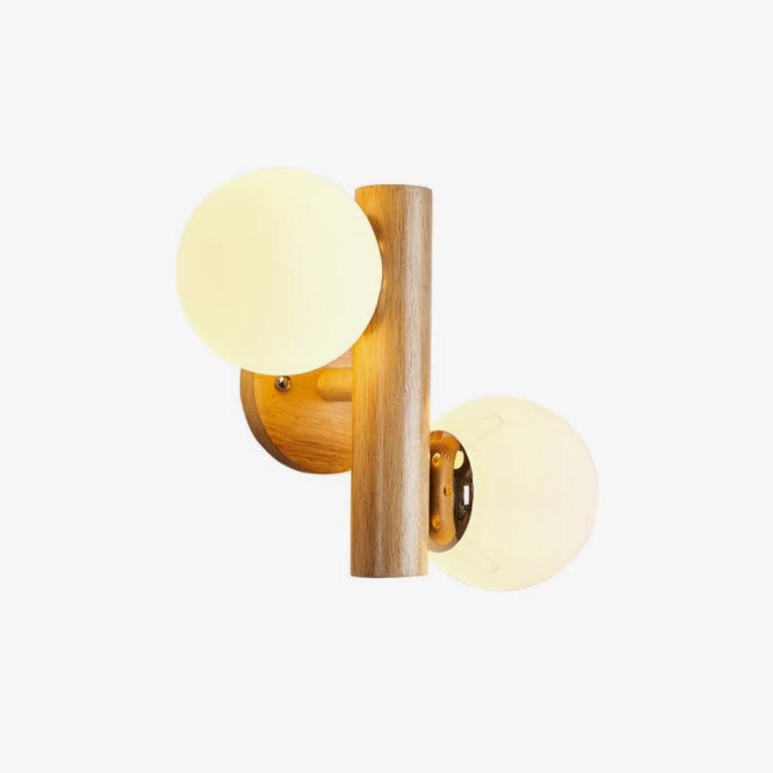 Clérachic wood sconce with softly lit cream globes and a round wooden backplate, photographed on a plain white background.