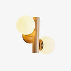 Clérachic wood sconce with softly lit cream globes and a round wooden backplate, photographed on a plain white background.