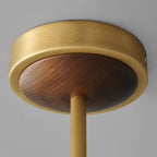 Close view of the antique brass ceiling canopy with a walnut centre on this Clérachic chandelier, and the rod below it.