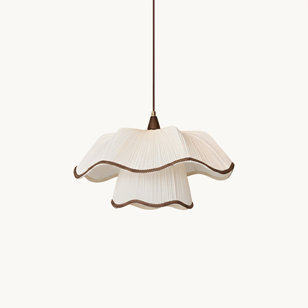 This Clérachic pendant on a plain white backdrop, with a two-tier pleated white shade, scalloped dark-brown trim and a thin brown cord.