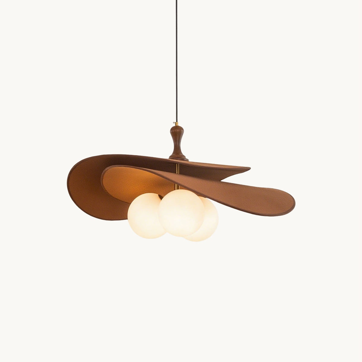 A Clérachic pendant with two layered brown wavy shades, a turned wood stem and three frosted white globes, hung on a plain white backdrop.