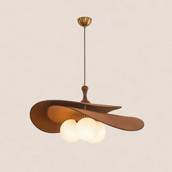Brown version of this Clérachic pendant on a soft beige backdrop, with a brass ceiling cup, black cord and three lit opal globes.