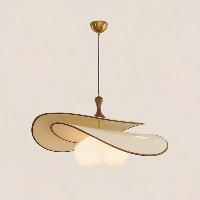 Beige version of this Clérachic pendant on a soft beige backdrop, with a brass ceiling cup, black cord and a cluster of lit opal globes.