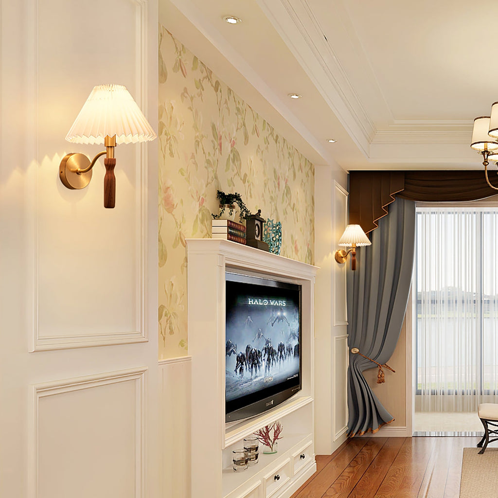 Distant view of a lit Clérachic wall light in a living room with panelled walls, a floral wallpaper panel and a wall-mounted television.