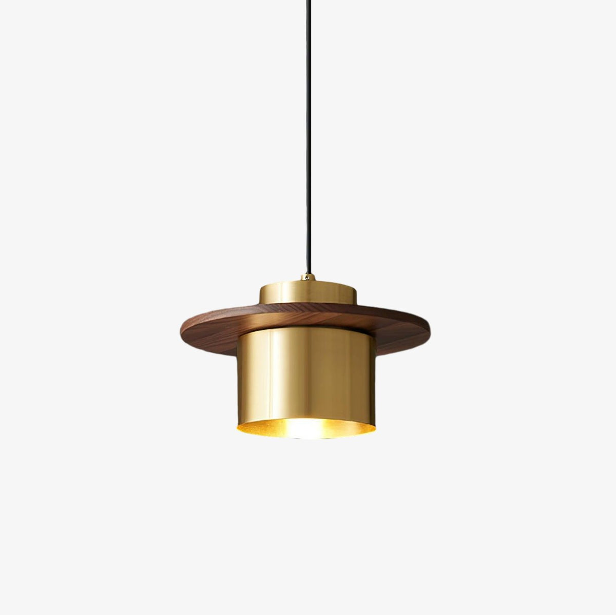 Clérachic pendant with a brass cylinder shade and a flat walnut disc, hung on a black cord against a plain white backdrop.