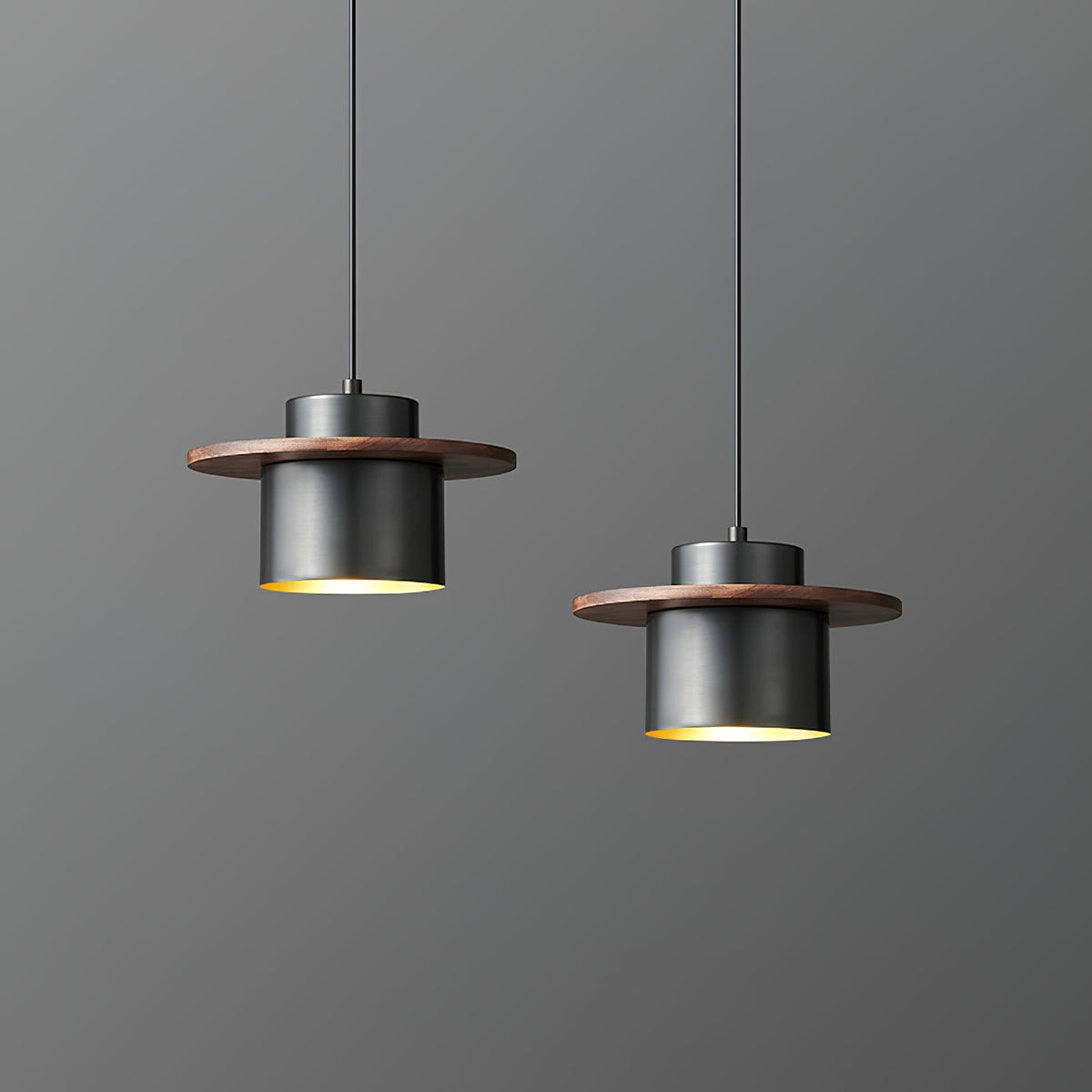 Two black-and-walnut Clérachic pendants hang at different heights, with a warm brass interior visible beneath each shade.
