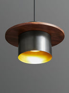 Low view into a black-and-walnut Clérachic pendant, showing the brass-coloured interior and a lit bulb.