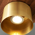 Looking up into the brass shade of this Clérachic pendant, with a ring-mounted bulb lit inside a warm brass interior.