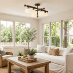 Frosted glass shades under crossed wood bars, a Clérachic semi flush light in a sunny living room with large windows.