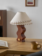 Smaller view of a Clérachic walnut table lamp on an oak desk, with an open book, a stoneware mug and a framed print.