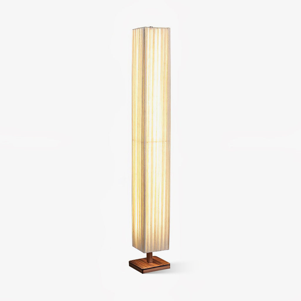 Tall square pleated fabric floor lamp from Clérachic on a small walnut wood base, shown on a plain white background.
