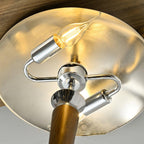 Looking up inside the chrome shade of this Clérachic floor lamp, a candle-style bulb on chrome arms below a silvered dome.