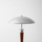 Close view of the chrome dome shade on this Clérachic floor lamp, above a walnut stem and a chrome collar.