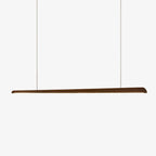 Slim tapered walnut bar pendant hung on two fine suspension wires against a plain white backdrop, from Clérachic.
