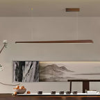 Clérachic walnut pendant with a small wooden ceiling plate, hung before a landscape painting and a low table of cups.