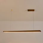 Clérachic walnut bar pendant lit with a warm amber glow along its underside, hung from a wooden ceiling plate.