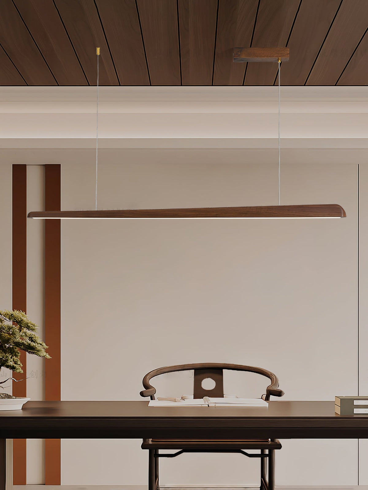 Walnut bar pendant beneath a wood-panelled ceiling, hung above a dark desk and carved chair, from Clérachic.