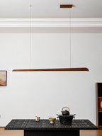Clérachic walnut bar pendant on two wires from a wooden ceiling plate, above a low black table with a teapot.