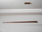 Clérachic walnut bar pendant hung from a small wooden ceiling plate beneath white cornice moulding.