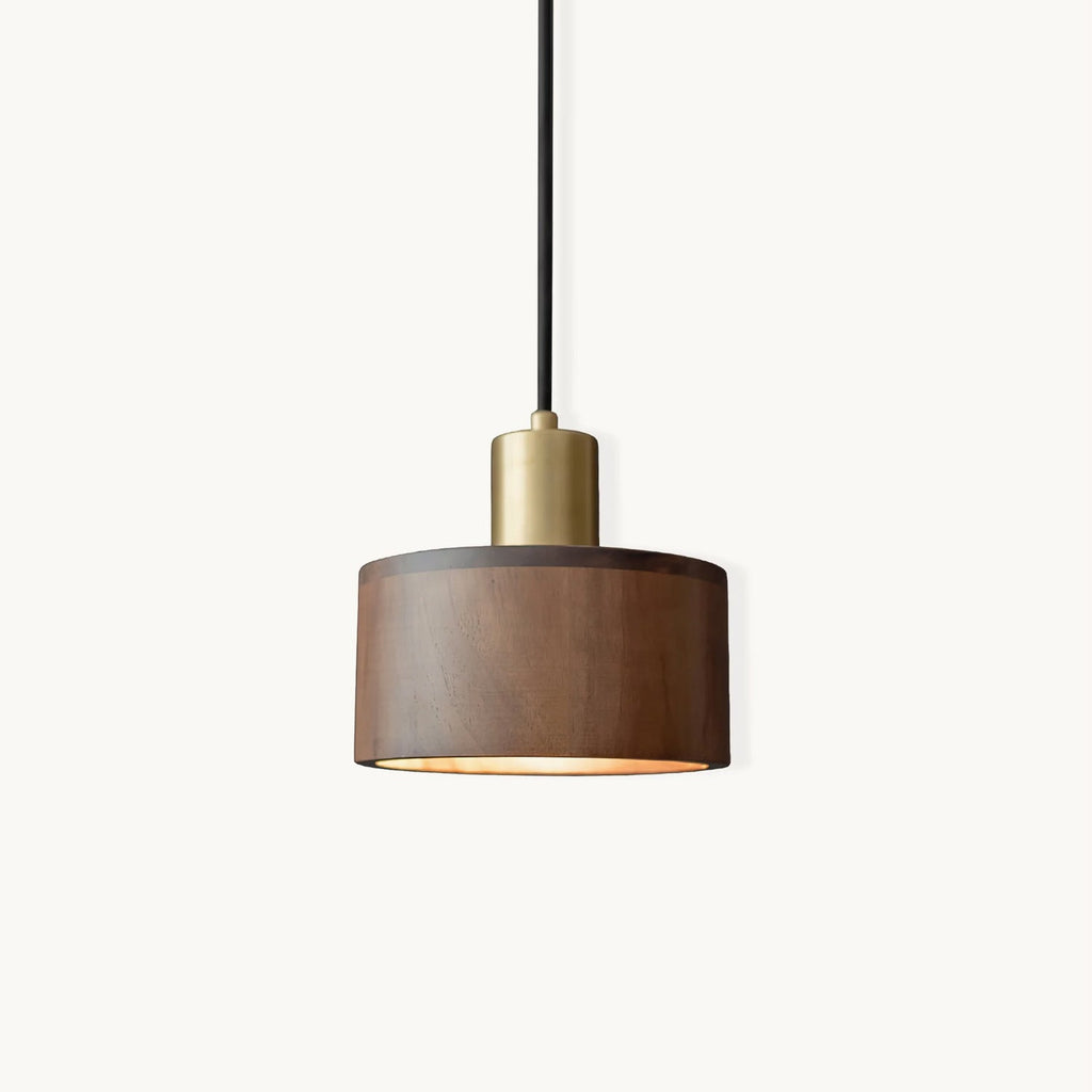 This Clérachic pendant on a plain white backdrop, a walnut drum shade with a brass cap and a thin black cord.