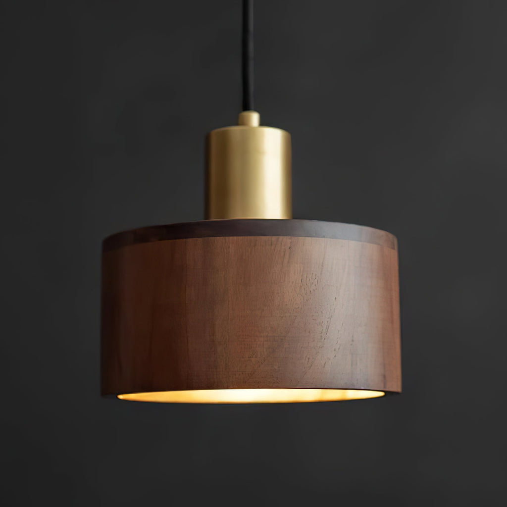 Seen from slightly below, this Clérachic pendant shows its straight walnut sides, a brass cap and a thin line of light at the rim.