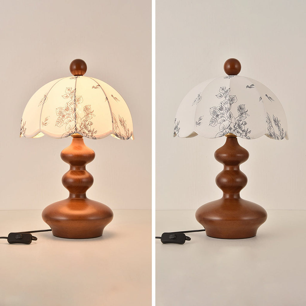 Two views of this Clérachic lamp with a rounded, tiered wooden base, lit and unlit, with its cord and switch to the left.