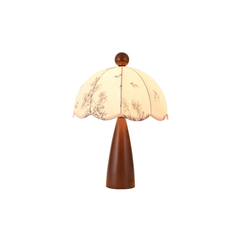 This Clérachic table lamp with a tapered wooden base and a scalloped floral shade, on a white background.